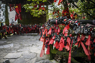 A bunch of make-a-wish red ribbons and good fortune locks containing Chinese symbols in the Wish Forest of Tianmen mountain (天门山) Zhangjiajie (张家界) National Park, China